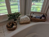 Basket of Bath decor and treats, including washcloths