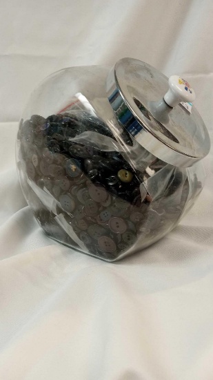 Glass Tilted jar filled with various dark-tone Vintage buttons