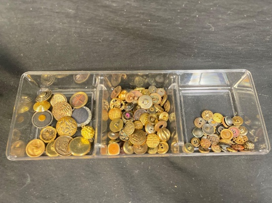Collection of vintage gold and brass-toned buttons, many of which appear to be meta