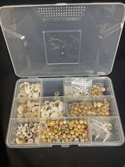 Organizer box filled with various types of beads, primarily resembling pearls and others