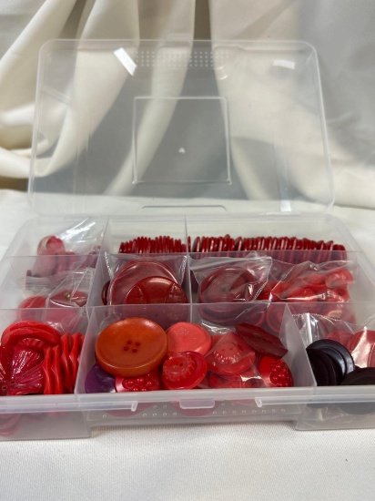Red-tone Vintage Button Collection in Clear Section Containers, Varying Shapes and Sizes