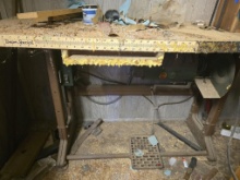Heavy-duty industrial sewing machine table with some kind of Shop machinery mounted