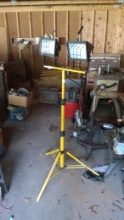 Twin-head portable halogen work light on a yellow telescoping tripod stand,