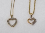 Two gold heart pendants on chains