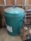 Green Lidded Trash Can with Roll of Wire Fencing