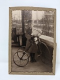 Photograph of Boy on Tricycle Holding Bunny