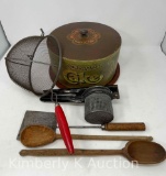 Vintage Kitchen Utensils Including a Colander, Ricer, Spatula, Wooden Spoons, and Tin Cake Saver
