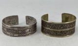 Two Early Cuff Bracelets - Early Ornate Silver (left) and Brass (right)