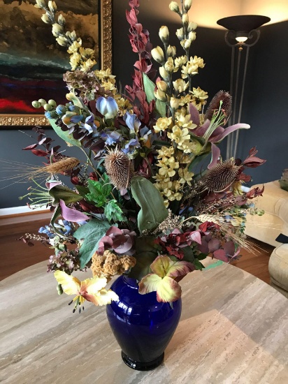 32? Floral arrangement and blue vase