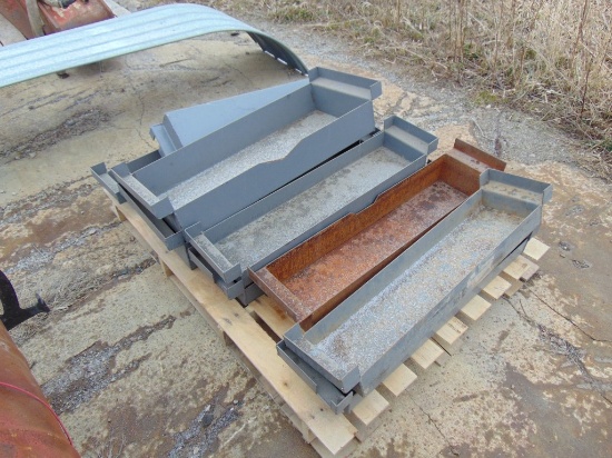 pallet of gray battery holders or brackets