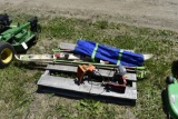 Pallet with skis, camping chairs, and two chainsaw sharpeners