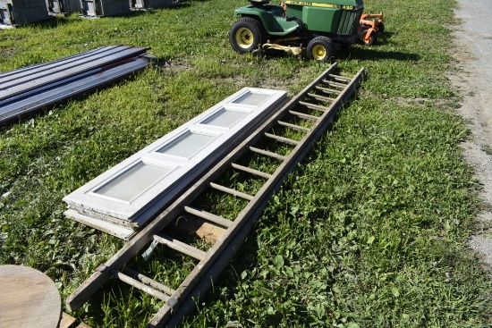 wooden 28 foot extension ladder and garage door panels