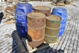 pallet with 3 metal barrels and 2 plastic liquid barrels