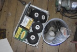 pale and tub full of grinding wheels, black tape and hack saw blades