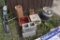 group of tile, chimney pipe, 2 cinderblocks, crate and gas can