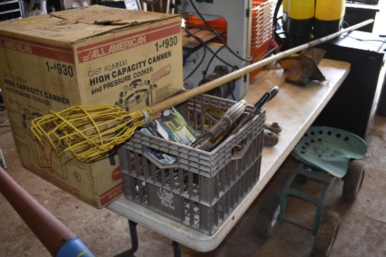 Crate with handsaws and apple picker