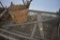 2 old saws and basket with cast iron ladle, blacksmith tongs, old wrench etc
