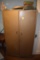 Bifold metal cabinet with books on top