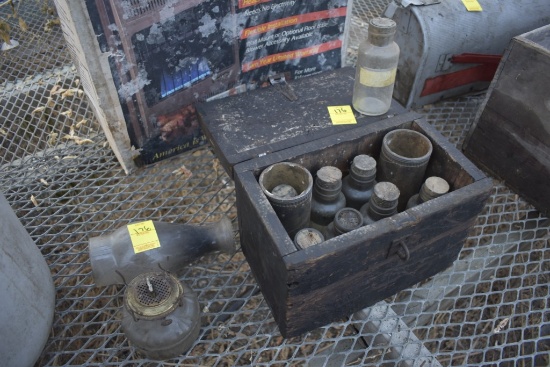 Antique wooden box with old bottles with corks and Gas Lantern