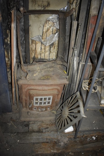 Antique indoor wood stove with two cooking surface plates