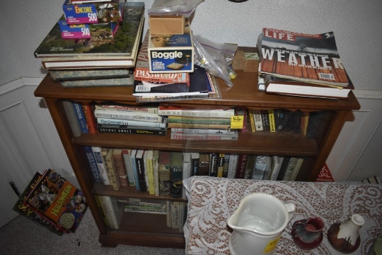 Bookshelf with all the books in and on and around it