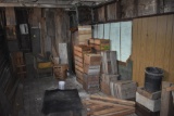 Group of fruit crates and old lumber with two green wooden chairs