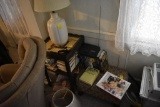 Table, light, group of books, and foot stool