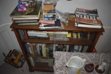 Bookshelf with all the books in and on and around it