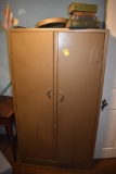 Bifold metal cabinet with books on top