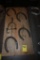 Four Horse Shoes and a Spur on a Wooden Plaque