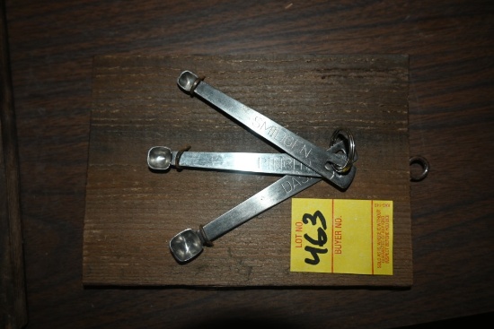 Three Measuring Spoons on a Wooden Plaque