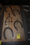 Four Horse Shoes and a Spur on a Wooden Plaque