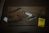 Four Bottle and Can Openers on a Wooden Plaque