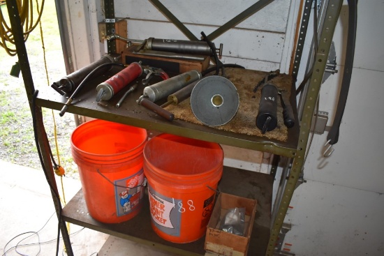 Contents Of Shelf  Grease Guns Extension Cord And Buckets Of Quick Dry