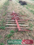 Manual windrower with wooden teeth