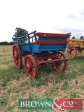4 wheeled wagon with high sides in blue and red livery