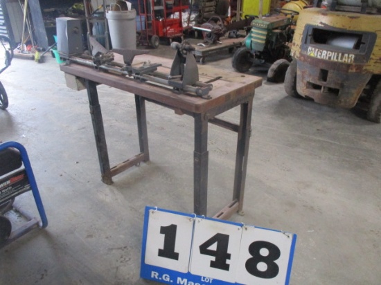 Belt drive wood lathe with adjustable table