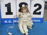 Porcelain doll has electrical cord - hands in box