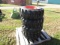 4 FORERUNNER 10-16.5 SKIDSTEER TIRES ON ORANGE