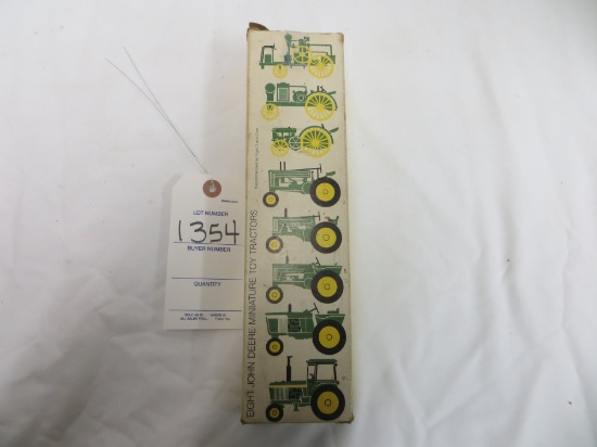 Eight JD miniature toy tractors  box poor