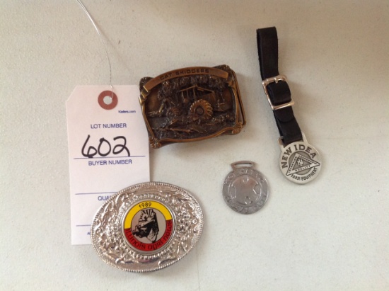 2 belt buckles 1 IL agri news and 1 Cat Skidder, and a New Idea Pfab and Ko