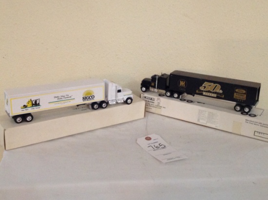 2 truck and trailers, a Sigco Sun Products and Ford New Holland 50th annive