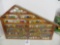 Large collection of John Deere marbles of all sizes in a barn display case