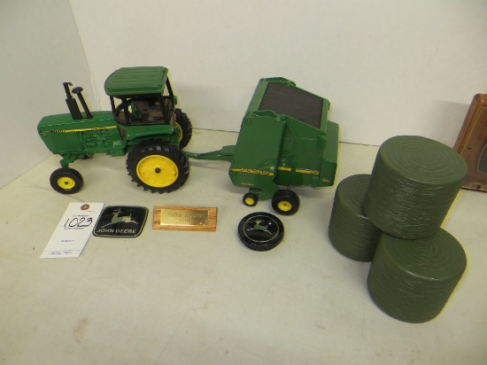 John Deere 4450 tractor w/567 round baler, 3 bales, 2 JD emblem & steering