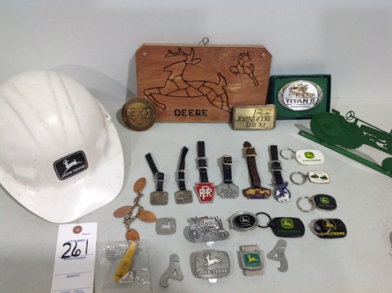 assortment of John Deere fobs, hard hat, belt buckles, money clip, key chains