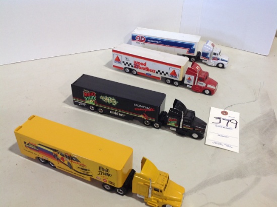 4 racing transporters semis