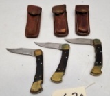 (3) Buck 110X Folding Knives with Leather Sheaths