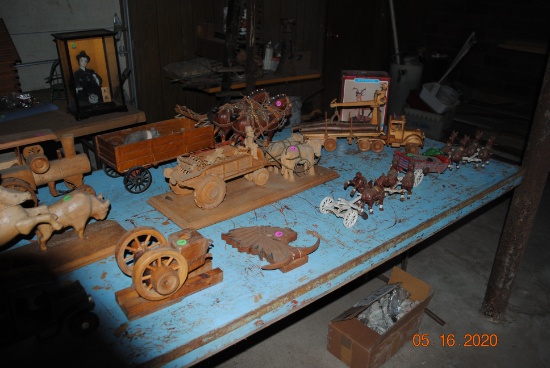 Table full of wooden toys including steam engine, hit & miss engine, logging truck, horse & wagon se