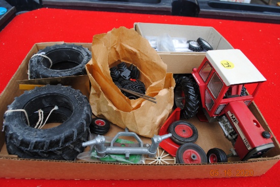 Box full of spare tires, wheels, suitcase weights & toy parts