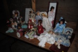 22 Assorted porcelain/ceramic dolls on stands